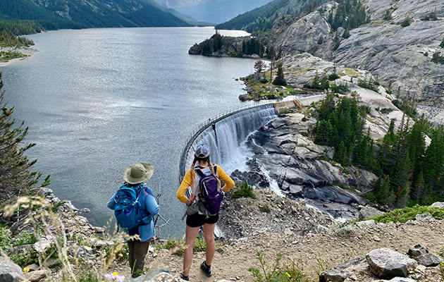 Two hikers take in the view of Mystic Lake.